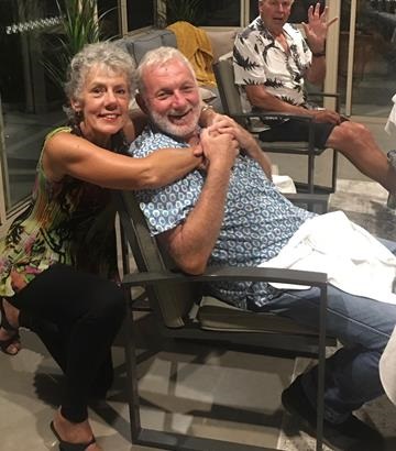Woman, Louis hugging her brother, Edward over the back of a chair