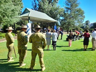 People some in uniform standing in Memorial Park