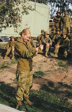 Woman with army fatigues with others watching